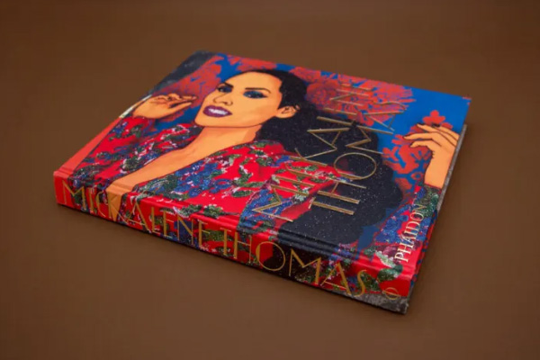 Four young football prospects sit and watch a lecture attentively 